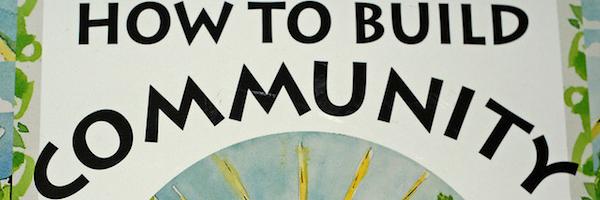 Hand-painted sign reading How to Build Community