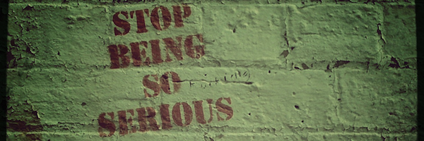Graffiti on a brick wall: Stop being so serious