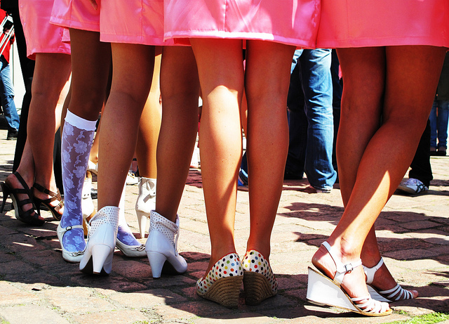 Row of airline flight attendants in pink uniforms and high heels